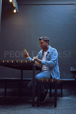 Buy stock photo Happy man, phone and browsing with coffee at cafe for social media, internet or connection. Young male person with smile on mobile smartphone for online chat or texting at indoor restaurant or shop
