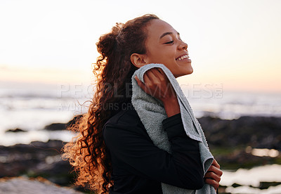 Buy stock photo Woman, towel and break after fitness at the beach, happy for wellness and yoga outdoor with zen and calm, Pilates, fresh air and morning workout routine with young yogi in nature, ocean and exercise