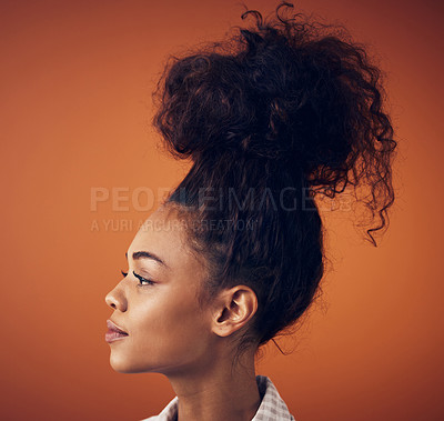 Buy stock photo Thinking, beauty and woman in studio for hair, cosmetics and style solution against orange background. Profile, planning and model with idea for natural haircare, mockup and steps for diy messy bun 