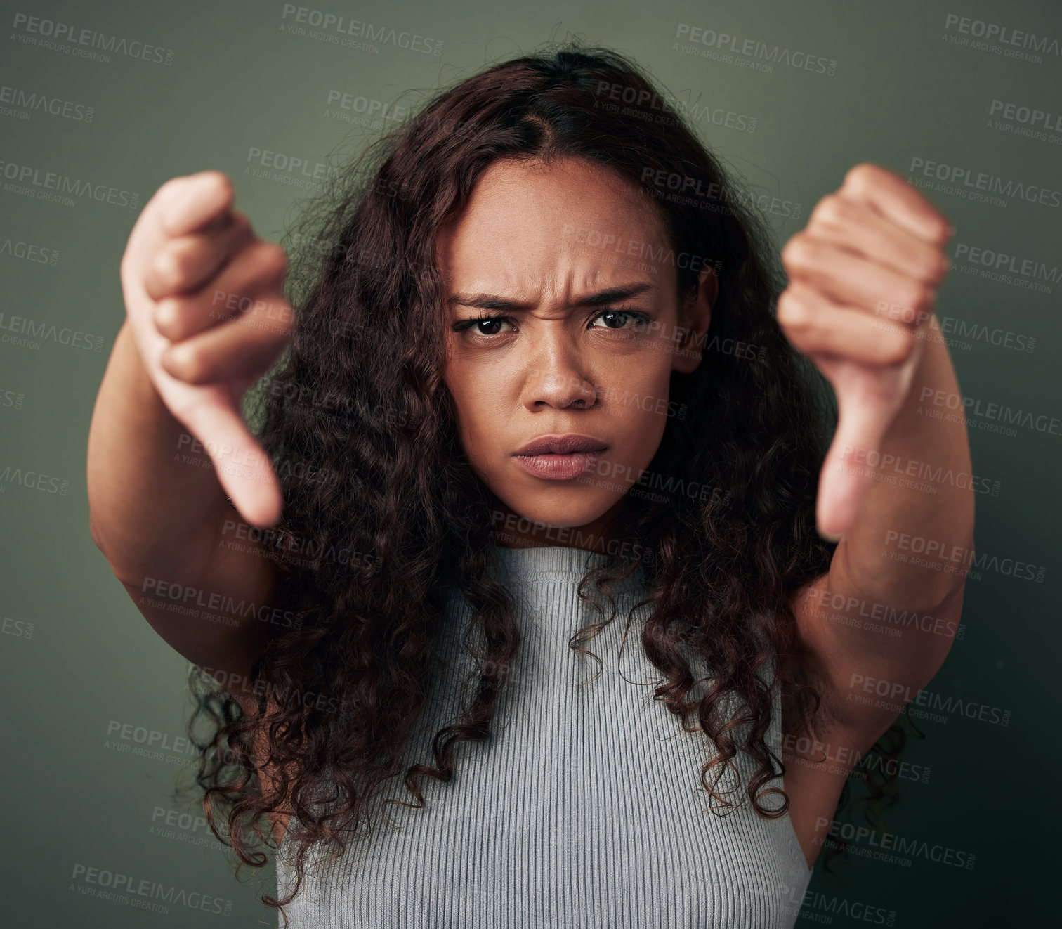 Buy stock photo Woman, thumbs down and angry, fail with hands, disagreement and negative mindset isolated on green background. Female person with bad review, feedback and problem with anger and dislike in studio