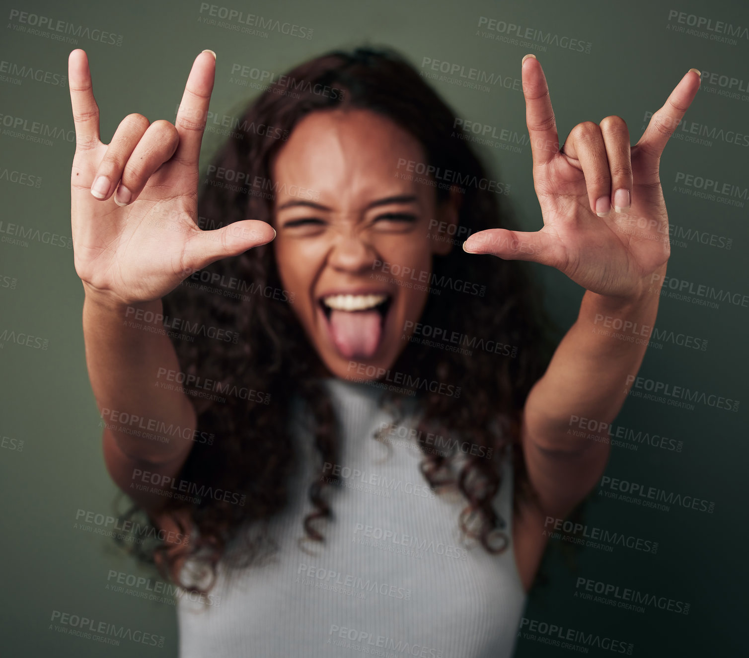 Buy stock photo Woman, portrait and rock hand in green studio background shows tongue with emoji and crazy. Female person, rocker and gesture with hands to celebrate or winning with excited face for a party.
