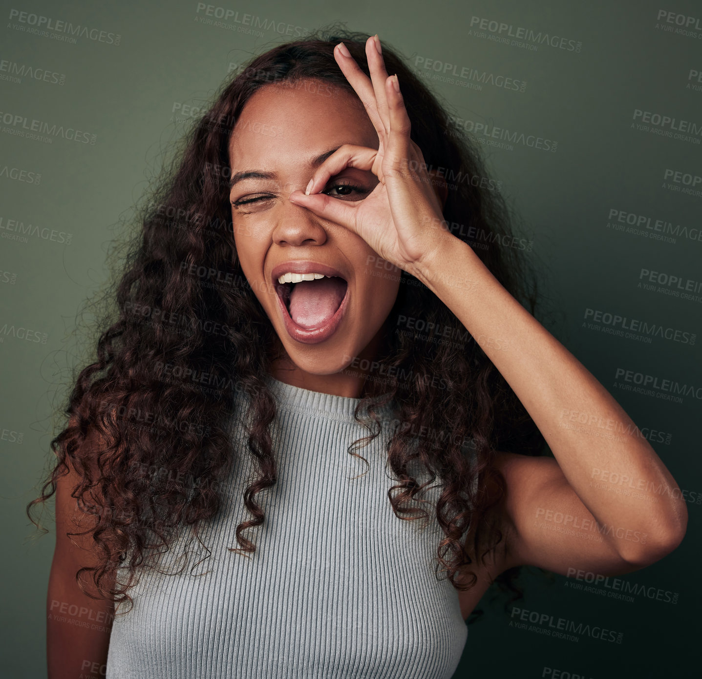 Buy stock photo Circle, hand and portrait of black girl in studio for peek a boo or i see you, perfect sign and wow. Woman, isolated and green background with ok gesture for feedback and expression with approval.