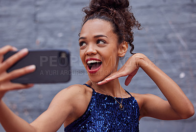Buy stock photo Cropped shot of a beautiful young woman taking a selfie while standing outside