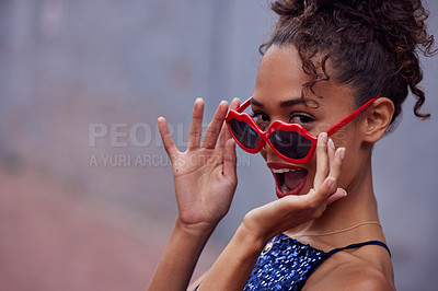 Buy stock photo Cropped shot of a beautiful young woman wearing funky glasses while standing outside