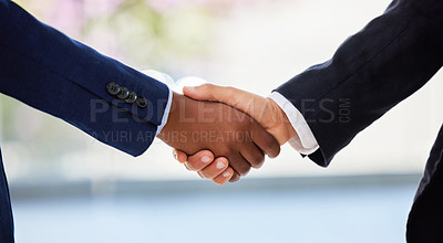 Buy stock photo Shot of two unrecognisable businessmen shaking hands in a modern office