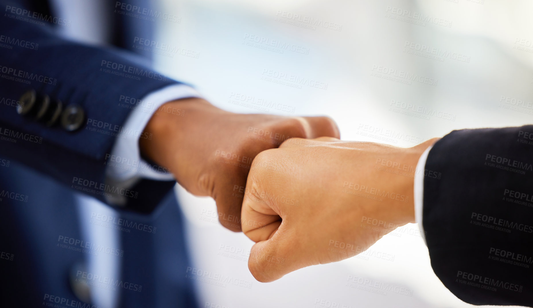 Buy stock photo Shot of two unrecognisable businessmen bumping fists in a modern office