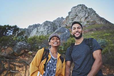 Buy stock photo Shot of a young couple hiking on a mountain range outdoors