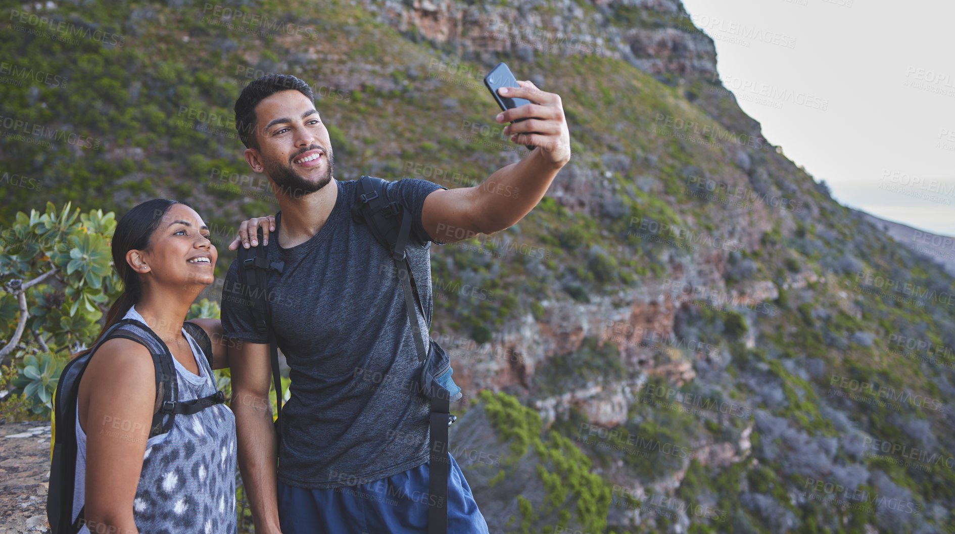 Buy stock photo Couple, selfie and happy for hiking on mountain with backpack, adventure and morning workout for fitness. People, trail walk and photo for fun memories, social media post and profile picture update
