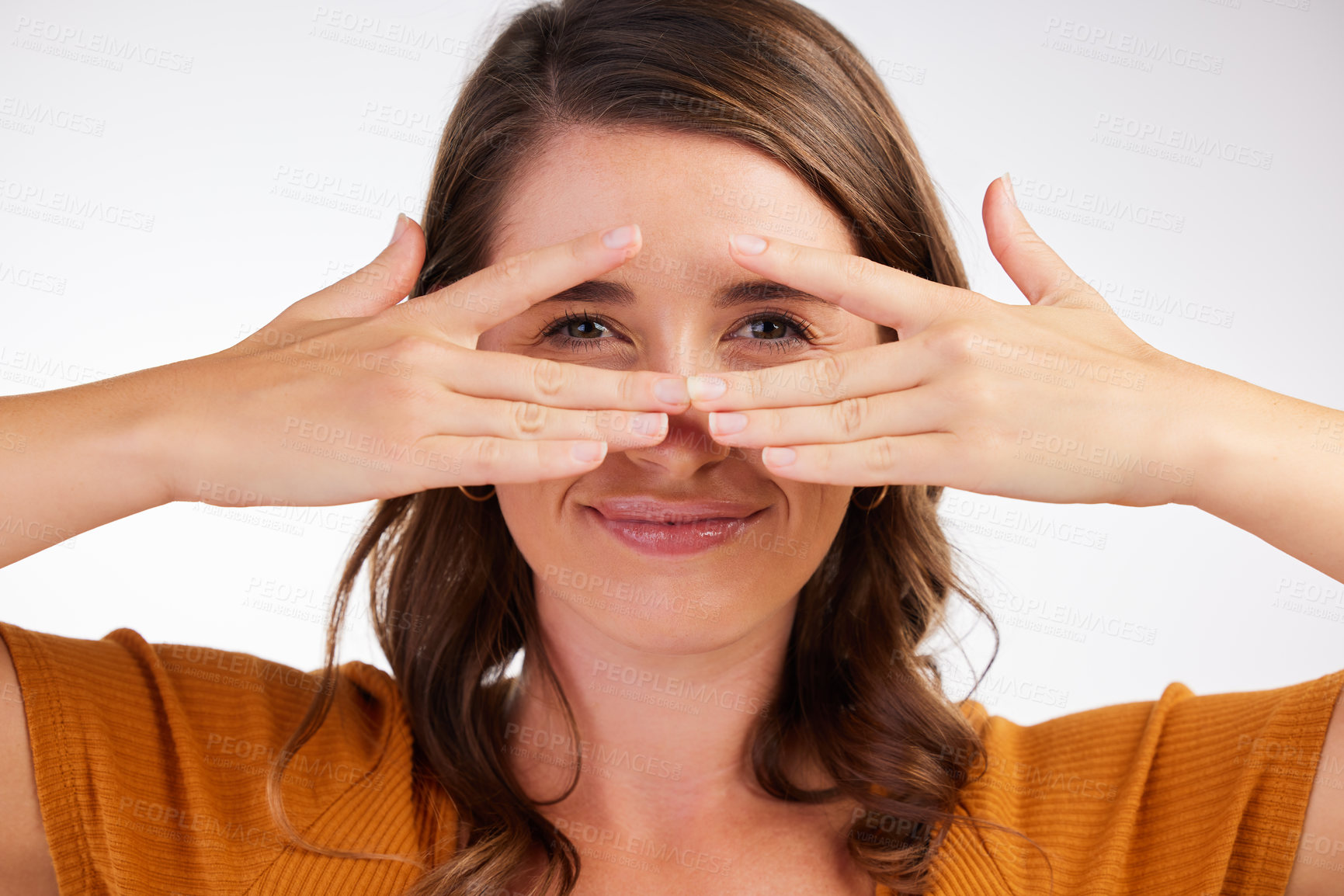 Buy stock photo Studio shot of a young woman covering her face with her hands against a white background