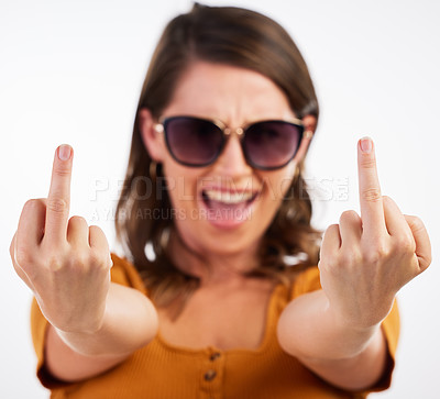 Buy stock photo Studio shot of a young woman showing her middle finger against a white background