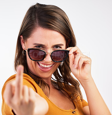 Buy stock photo Studio, portrait and woman with rude middle finger, glasses and comedy expression. Face, smile and rebel from female model with hand gesture, comedy and silly joke with attitude and emoji and curse