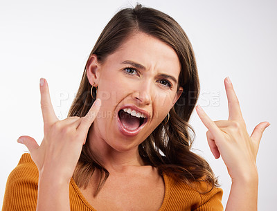 Buy stock photo Excited, rocker hands and portrait of woman in studio with energy, confidence and fun on white background. Punk, emoji and face of model with shouting, freedom and sign music, band or concern support