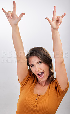 Buy stock photo Freedom, rocker hands and portrait of woman in studio with energy, confidence and fun on white background. Punk, emoji and face of model excited, shouting and sign for music, band or concert support