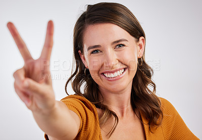Buy stock photo Peace sign, happy and portrait with woman and smile with emoji, excited and hand gesture in studio. University student, casual and modern fashion with clothes and confidence with white background