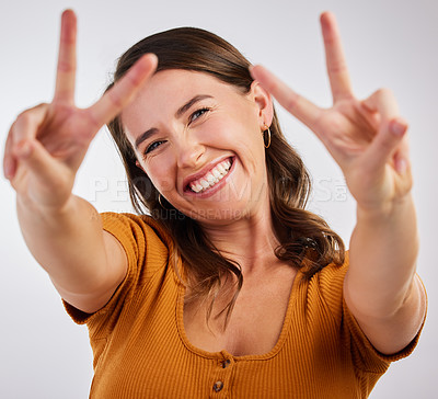 Buy stock photo Peace sign, excited and portrait with woman and smile with emoji, happy and hand gesture in studio. University student, casual and modern fashion with clothes and confidence with white background