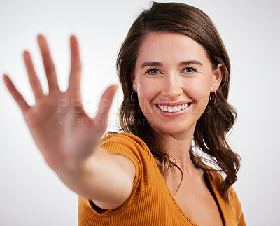 Buy stock photo Studio shot of a young woman showing the palm of her hand against a white background