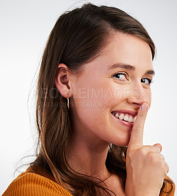 Buy stock photo Portrait, happy woman and finger on lips in studio with secret, gossip and private news on white background. Whisper, face and model with sneaky drama, mystery and confidential, information and emoji