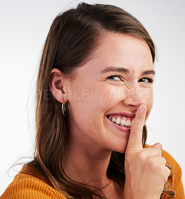 Buy stock photo Portrait, excited woman and finger on lips in studio with secret, gossip or private news on white background. Whisper, face and model with sneaky drama, mystery and confidential, information or emoji