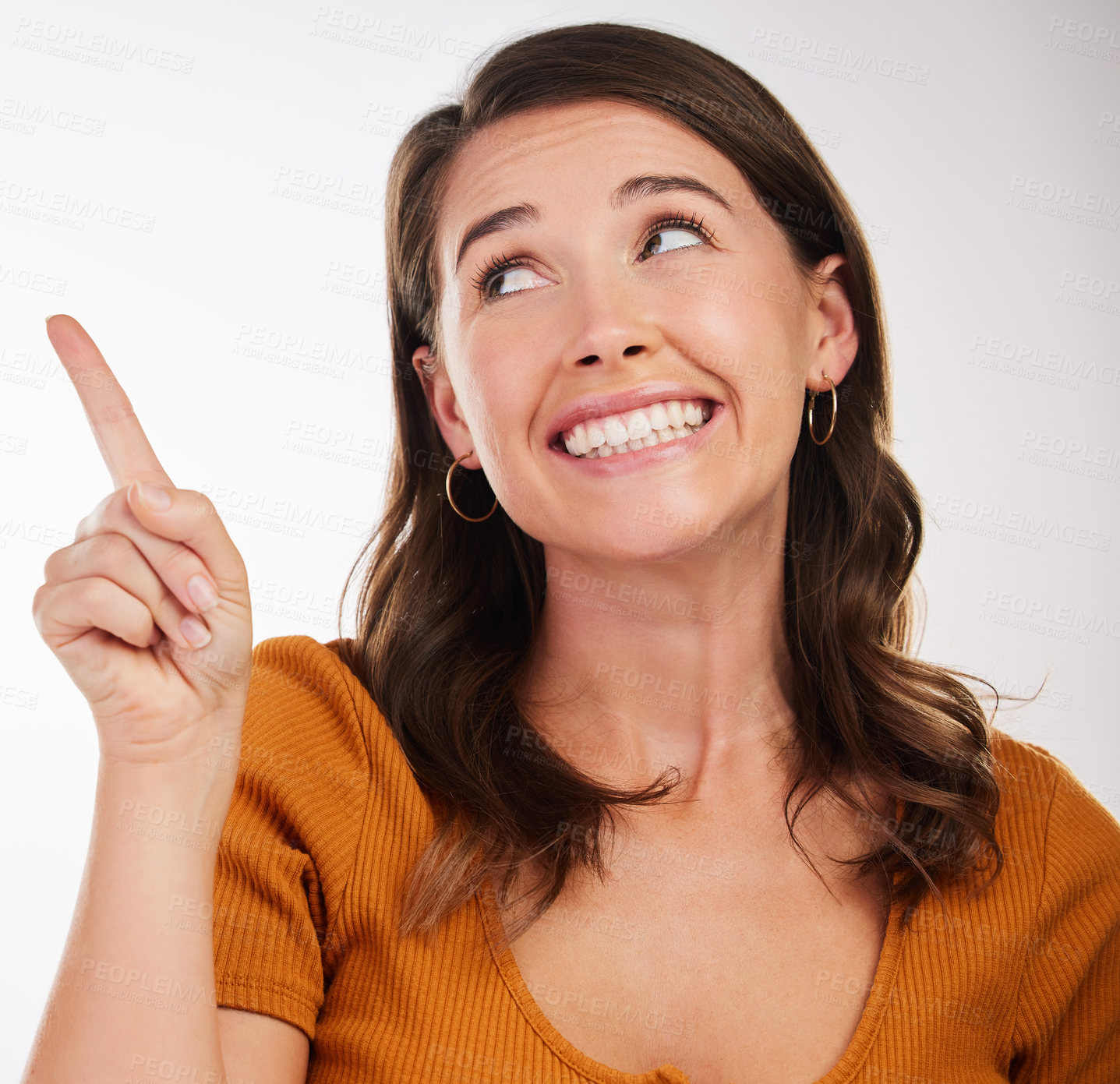 Buy stock photo Thinking, smile and woman with hand pointing in studio looking up for announcement, promo or sign up info on white background. Shy, face or model with finger emoji for question, ask or volunteering