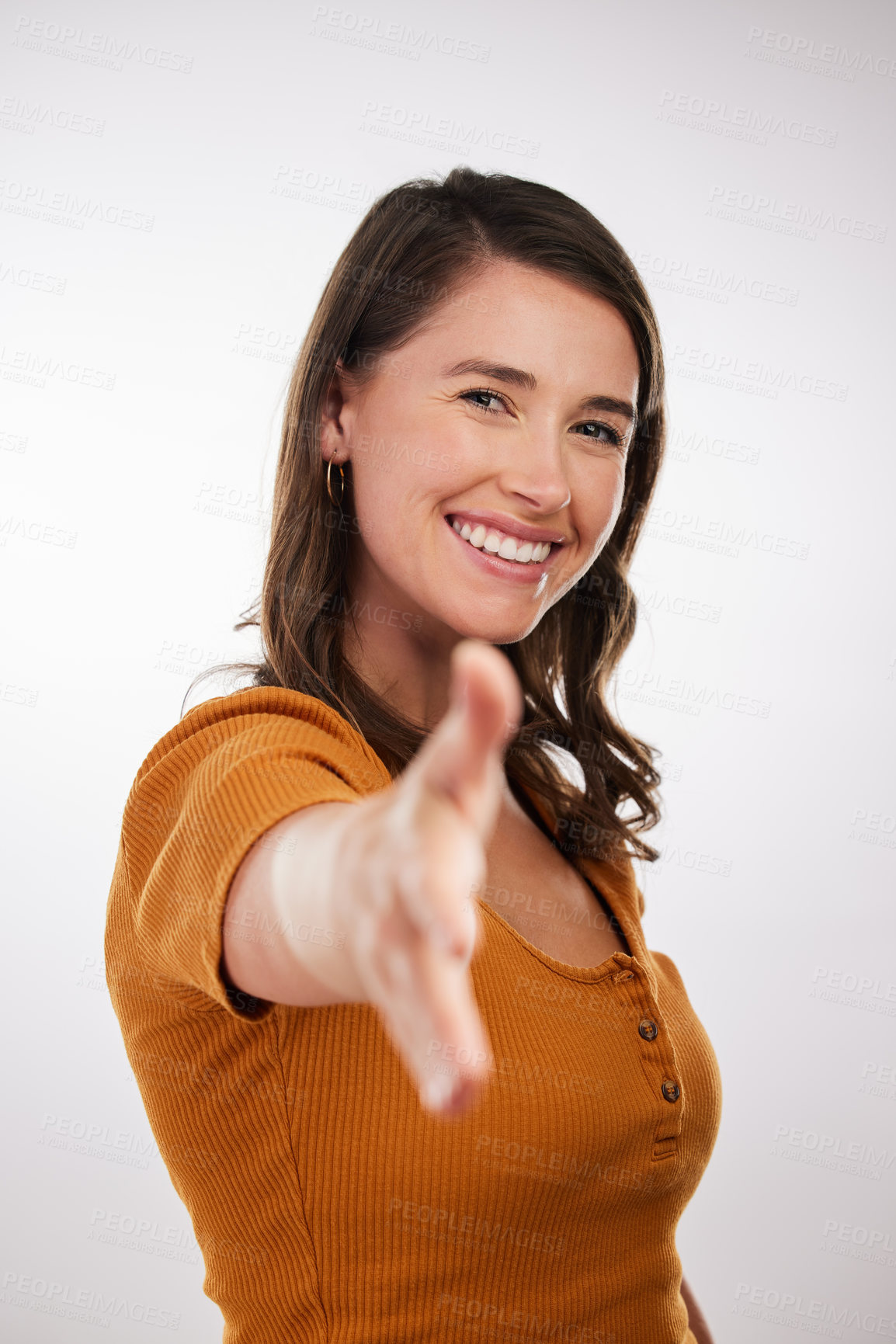 Buy stock photo Studio shot of a young woman stretching out her hand against a white background