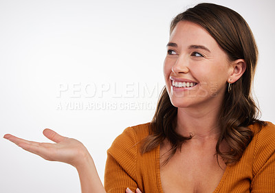 Buy stock photo Studio, woman and hand for product placement with mockup space on white background. Gesture, advert and commercial promotion for announcement or deal by female model, presentation or sale with smile 