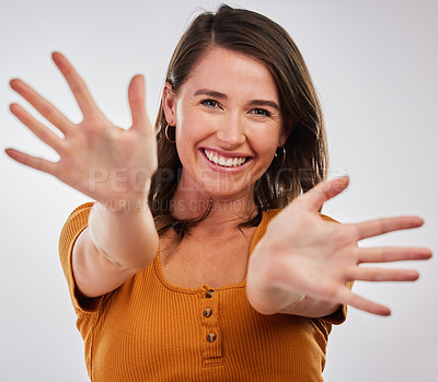 Buy stock photo Studio shot of a young woman showing the palm of her hands against a white background