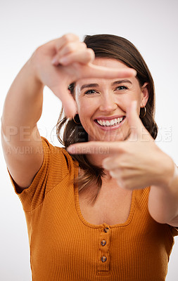Buy stock photo Finger frame, portrait and cheerful woman in studio for photography, perspective or focus with white background. Model, happiness and face of female person with hand gesture, symbol or capture