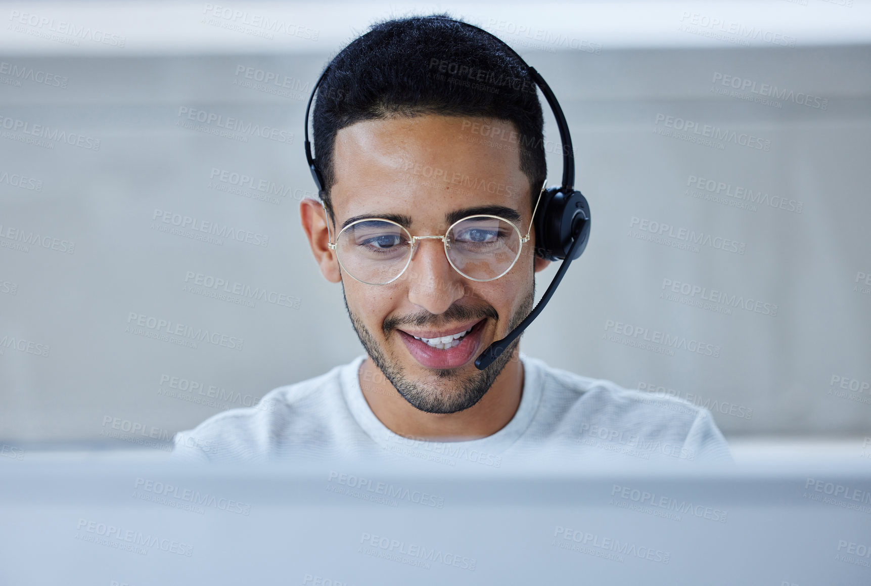 Buy stock photo Shot of a young businessman working at his desk in his office