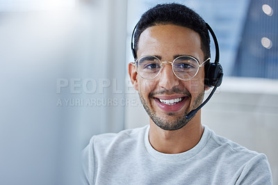 Buy stock photo Shot of a young businessman working at his desk in his office