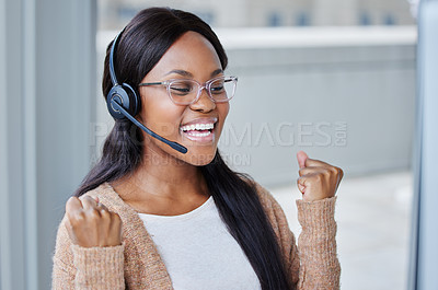 Buy stock photo Shot of an excited businesswoman sitting at her desk in her call center office