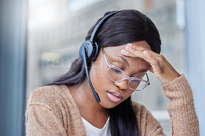 Buy stock photo Shot of a businesswoman suffering with a migraine at her desk in her office