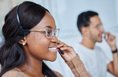 Buy stock photo Shot of male and female colleagues working together in their office at a call center