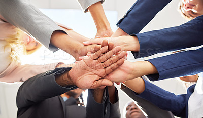 Buy stock photo Shot of a group of coworkers huddling their hands together in team sprit