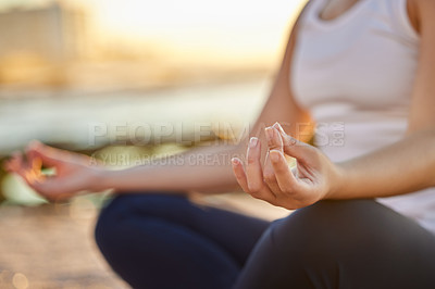 Buy stock photo Cropped shot of an unrecognizable young woman meditating on the beach