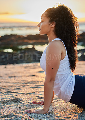 Buy stock photo Cropped shot of an attractive young woman practicing yoga on the beach