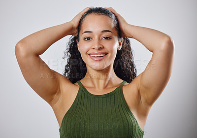 Buy stock photo Cropped shot of a woman touching her wet hair against a grey background