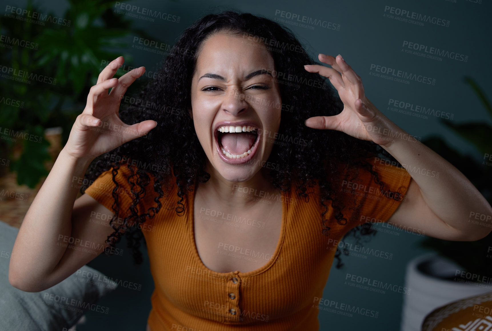 Buy stock photo Shot of a young woman feeling angry at home
