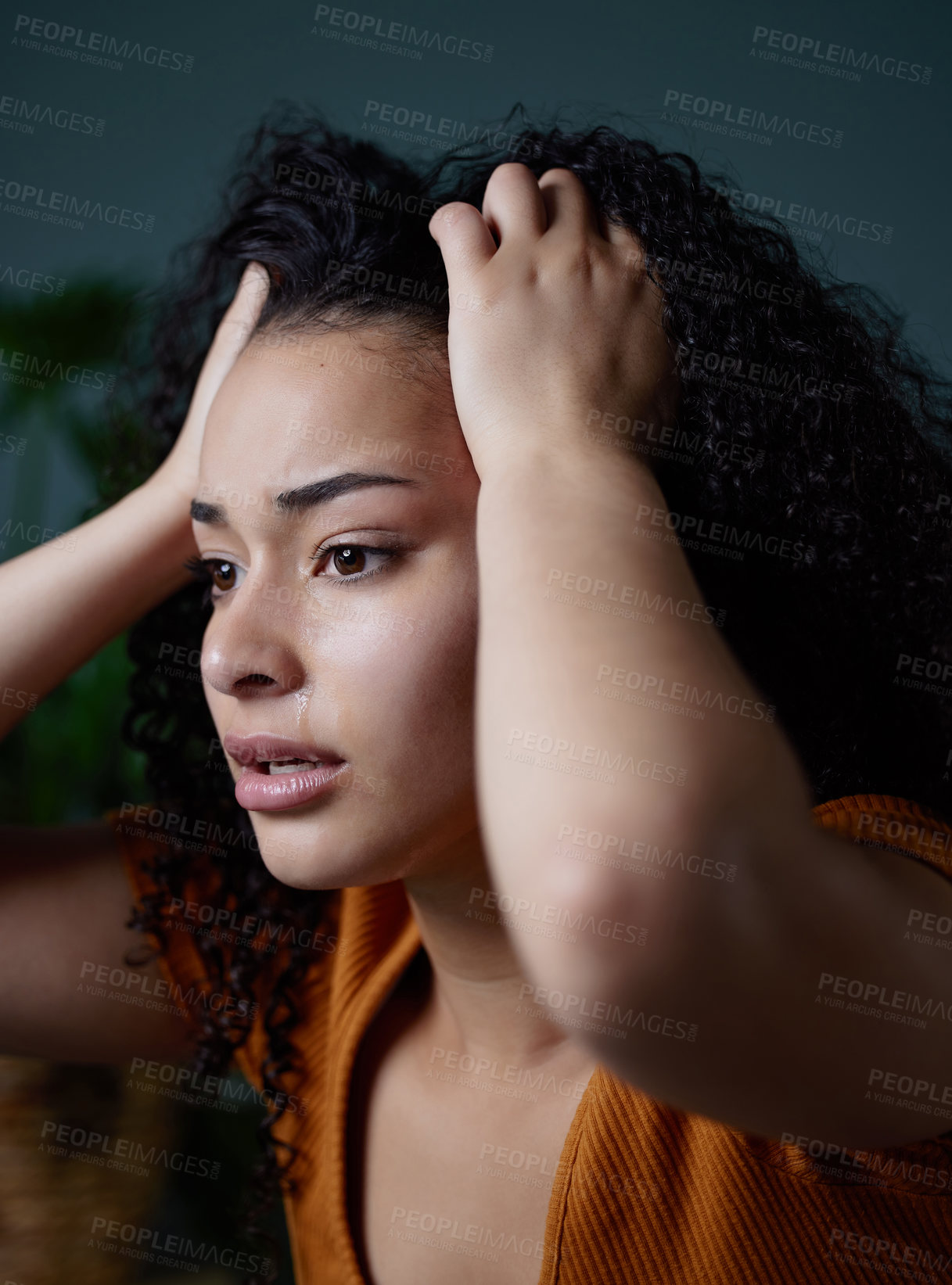 Buy stock photo Shot of a young woman feeling anxious at home