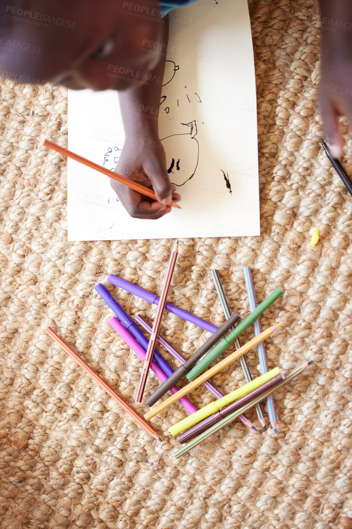 Buy stock photo Shot of a young boy sitting on the floor drawing pictures