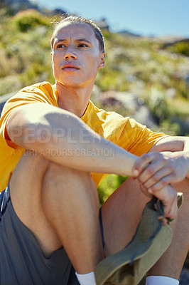 Buy stock photo Shot of a young man taking a break to admire the view mid hike