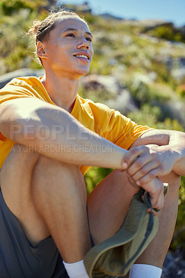 Buy stock photo Shot of a young man taking a break to admire the view mid hike