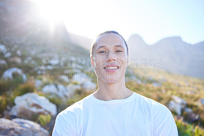 Buy stock photo Cropped portrait of a handsome young man during his early morning hike through the mountains