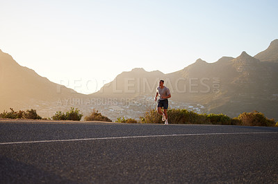 Buy stock photo Shot of a young man running alone outside