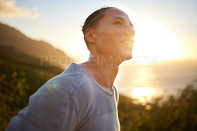 Buy stock photo Shot of a young taking a breather during his outdoor training