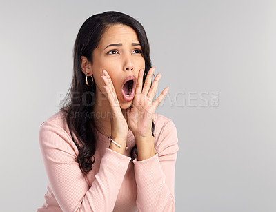 Buy stock photo Shot of a beautiful young woman shouting while standing against a grey background