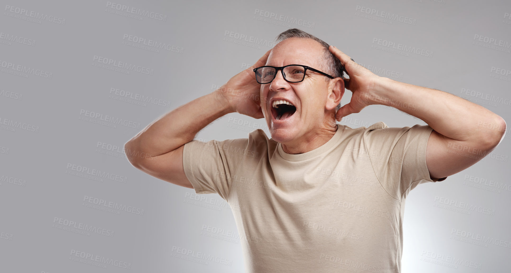 Buy stock photo Shot of a handsome mature man standing alone against a grey background with his hands behind his head
