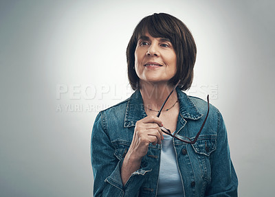 Buy stock photo Studio shot of a senior woman looking thoughtful against a grey background