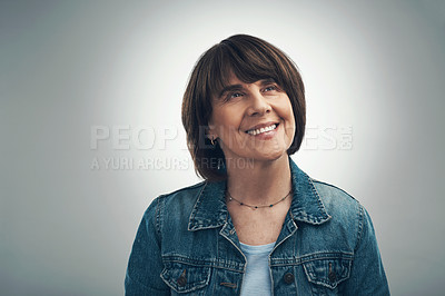 Buy stock photo Studio shot of a senior woman looking thoughtful against a grey background
