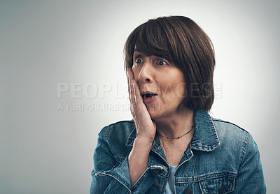 Buy stock photo Studio shot of a senior woman looking shocked against a grey background