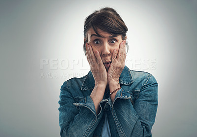 Buy stock photo Studio portrait of a senior woman looking shocked against a grey background